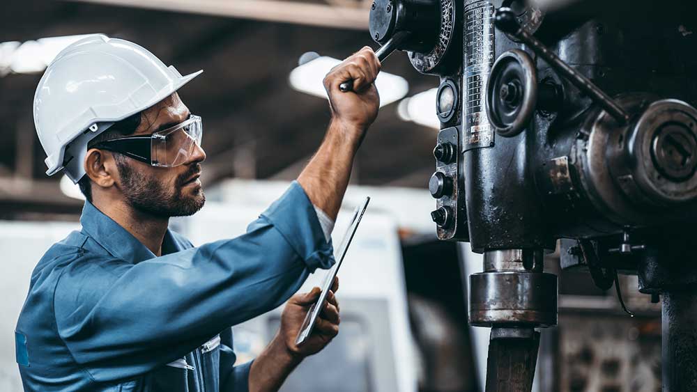 man working in an industrial plant on a machine